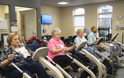 Seniors using exercise equipment in the cardiac rehab center